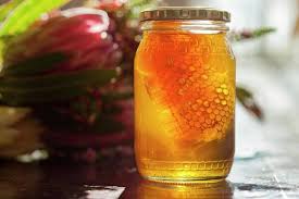 Jar of honey with honeycomb